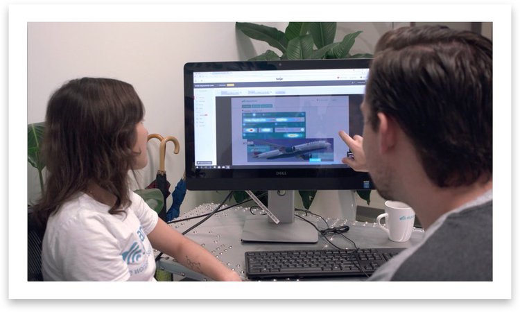 a man and woman looking at a heatmap together on a computer screen in an office